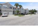 A row of townhomes with well-maintained landscaping and a gray exterior at 568 Shoreham Ne Ct, St Petersburg, FL 33716