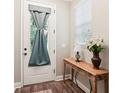 Bright entryway featuring a table, vase with white lilies, and a window offering natural light at 6005 Shell Ridge Dr, Lithia, FL 33547