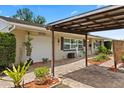 Covered carport and brick driveway enhance this home's curb appeal with an attached garage at 6698 35Th N Ave, St Petersburg, FL 33710