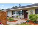 Inviting front porch with brick pavers, rocking chairs, and a decorative front door at 6698 35Th N Ave, St Petersburg, FL 33710