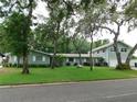 Charming single-Gathering home with mature trees and lush green lawn on a quiet street at 888 Forest Glen Rd, Clearwater, FL 33765