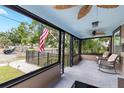 Inviting enclosed front porch with comfortable seating and ceiling fans at 931 28Th N Ave, St Petersburg, FL 33704
