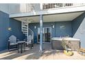 Inviting covered patio with a hot tub, spiral staircase, seating area, and access to the waterfront at 9939 1St E St, Treasure Island, FL 33706