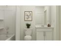 Bright bathroom featuring a shower-tub combination and white single sink vanity at 11926 Brae Way, Dade City, FL 33525