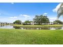 Scenic view of the building complex overlooking a tranquil pond with lush green landscaping at 143 Lakeside Dr # 143, Oldsmar, FL 34677