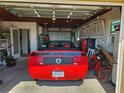 A clean and organized garage with a red convertible parked inside at 1447 Lemon Bay Dr, Englewood, FL 34223