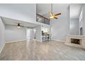 Open living space with high ceilings, tile floors, fireplace, and bar seating at 1815 Cypress Trace Dr, Safety Harbor, FL 34695