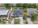 Aerial view of a well-maintained home with a spacious backyard, driveway, and lush greenery surrounding the property at 19212 Sunlake Blvd, Lutz, FL 33558