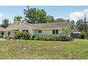 Charming single-story home featuring lush greenery and a spacious lawn at 2626 Cheryle Ln, Sarasota, FL 34237