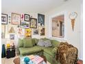 Stylish living room featuring a comfortable green sofa and unique wall art at 2627 8Th N Ave, St Petersburg, FL 33713
