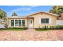Charming single Gathering home featuring well-maintained landscaping and a brick paver driveway at 281 44Th Ave, St Pete Beach, FL 33706