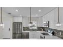 Modern kitchen features white cabinets, stainless steel appliances, and stylish backsplash at 281 44Th Ave, St Pete Beach, FL 33706