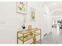 Inviting hallway with tiled flooring, neutral walls, and stylish decor at 2906 Boxwood Grove Row, Wesley Chapel, FL 33543