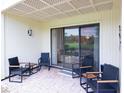 Cozy outdoor patio featuring comfortable chairs, a brick floor, and views of the golf course at 29147 Bay Hollow Dr # 3217, Wesley Chapel, FL 33543