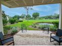 Relaxing patio with comfortable seating overlooking a well-manicured golf course and pond at 29147 Bay Hollow Dr # 3217, Wesley Chapel, FL 33543