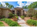 Attractive home featuring brick archway entrance, with well-maintained landscaping and walkway at 2963 Cielo N Cir, Clearwater, FL 33759