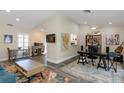 Spacious living area featuring vaulted ceilings, wood flooring, and plenty of natural light at 322 Windrush Loop # 22, Tarpon Springs, FL 34689