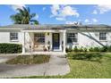 Inviting front entrance with a bench and walkway leading to the vibrant blue front door at 4103 W Bay Villa Ave, Tampa, FL 33611
