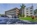 Multi-story exterior featuring palm trees and parking at 6190 80Th N St # 411, St Petersburg, FL 33709