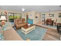 Inviting living room with comfortable seating, wood floors, ceiling fan, and natural light at 6190 80Th N St # 411, St Petersburg, FL 33709