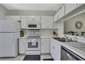 Functional kitchen features white cabinets, modern appliances, and an efficient layout at 6231 Bayside Key Dr, Tampa, FL 33615