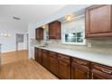 Beautiful kitchen with granite countertops, stainless steel sink, wood cabinets, and modern fixtures at 7777 117Th St, Seminole, FL 33772