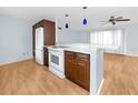 Modern kitchen featuring stainless steel appliances, wood cabinets, and an open layout at 7777 117Th St, Seminole, FL 33772