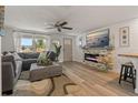 Comfortable living room with a stone fireplace, modern lighting, and stylish furnishings at 7909 Canna Dr, Port Richey, FL 34668