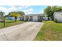Charming single Gathering home with a garage and a long driveway, perfect for multiple cars at 9126 Greenbriar Ln, Port Richey, FL 34668