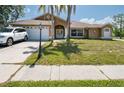 Charming one story home featuring a well-manicured lawn and inviting double door entry at 10149 Briar Cir, Hudson, FL 34667