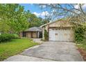 Home's exterior, showing an attached garage and in-law suite at 1021 15Th St, Palm Harbor, FL 34683