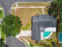 Aerial shot of property showcasing the home, backyard pool, and landscaped lawn at 10408 Butia Pl, Tampa, FL 33618