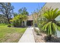 Inviting home entrance with lush tropical landscaping and a walkway at 11203 Killearn Ct, Riverview, FL 33569