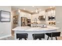 Modern kitchen with white cabinetry, stainless steel appliances, a spacious island, and pendant lighting at 11236 Kingly Ln, Odessa, FL 33556