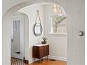 Foyer with arched doorway, a mirror, pendant lights, and hardwood floors at 126 14Th Ne Ave, St Petersburg, FL 33701