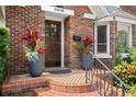 Inviting front entrance with decorative planters and patterned tile steps at 126 14Th Ne Ave, St Petersburg, FL 33701