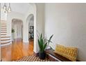 Bright hallway with arched doorways, hardwood floors and decorative bench at 126 14Th Ne Ave, St Petersburg, FL 33701