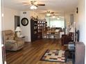 Spacious living room with hardwood floors, ceiling fans and plenty of natural light at 2020 World Parkway Blvd # 12, Clearwater, FL 33763
