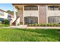 Inviting condo with a well-manicured lawn and attractive architectural details at 2969 Bonaventure Cir # 104, Palm Harbor, FL 34684
