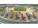 Aerial view of homes in a neatly planned neighborhood with manicured lawns and access to lakes at 3166 Francoa Dr, Odessa, FL 33556