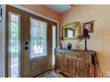 Elegant entryway showcasing leaded glass front door, a decorative cabinet, and tiled flooring at 3406 Hollyhock Way, Tampa, FL 33618