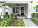 Inviting front porch with seating and ceiling fan, perfect for relaxing outdoors at 3757 Villamore Ln, Odessa, FL 33556