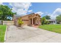 Well-kept single-story home with a driveway, garage and landscaped lawn at 39055 9Th Ave, Zephyrhills, FL 33542