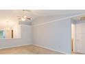 Open-concept living room featuring vaulted ceilings, ceiling fan, and tile flooring at 39055 9Th Ave, Zephyrhills, FL 33542