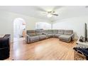 Bright and spacious living room features hardwood floors and a large sectional sofa at 4732 Ashburn Pond Way, Tampa, FL 33610