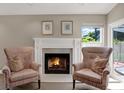 Cozy living space features a fireplace flanked by patterned chairs, with natural light from a nearby window at 500 Westborough Ln, Safety Harbor, FL 34695