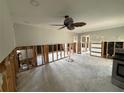 Spacious living room awaiting renovation, featuring a ceiling fan and ample natural light at 5201 Denver Ne St, St Petersburg, FL 33703