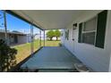 Wide angle view of the home's carport entrance, featuring a covered concrete pad and access to the front door at 5318 Mary St, Zephyrhills, FL 33542