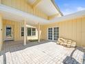Spacious outdoor patio featuring neutral flooring, pillars, and ample natural light from french doors and large windows at 5409 Pali Way, St Pete Beach, FL 33706