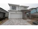 New construction home with stone entryway, white facade, and wide paved driveway and two-car garage at 648 Allora Ave, Nokomis, FL 34275